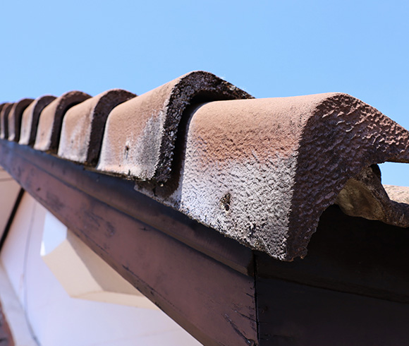 close up of a terracotta roof tile edge against a clear blue sky showcasing roofing details and textures perfect for residential designs 2 styles and materials