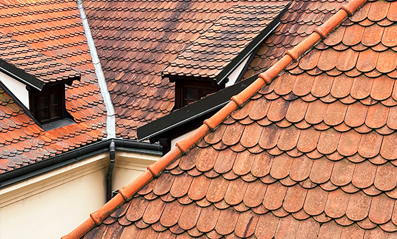 rooftops with red clay tiles showing patterns of texture and design emphasizing traditional architecture and home improvement