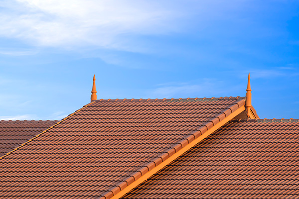 rooftops with decorative peaks against a clear blue sky highlighting three distinct angles of design