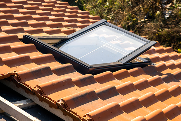 skylight on a terracotta roof with a clear glass window allowing natural light to enter the building enhancing interior space and functionality for home design