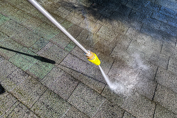 high-pressure washer cleaning surface with water showcasing effective outdoor cleaning techniques 2 ways to restore surfaces