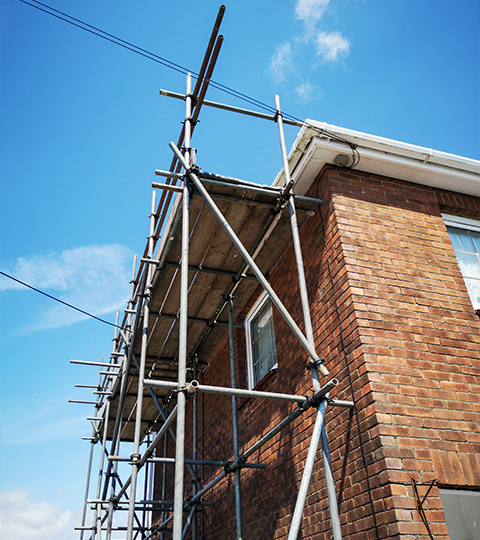 scaffolding structure on brick building under blue sky construction site safety equipment