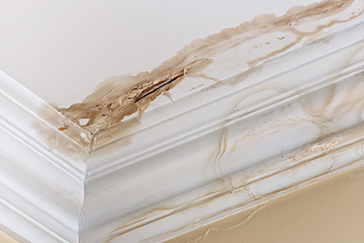 water damage stain on ceiling with peeling paint and discoloration caused by leaks and moisture issues in home renovation projects