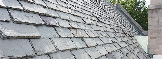 slate roofing shingles on a sloped roof demonstrating durable construction and design features for homes and buildings