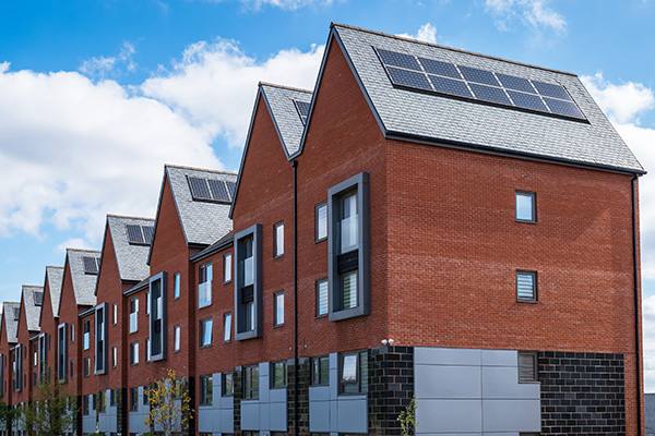 row of modern houses with solar panels on roofs showcasing sustainable living and energy efficiency