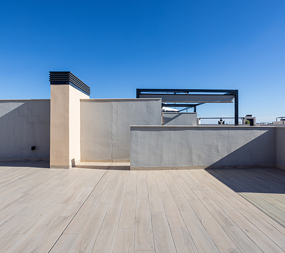 open rooftop terrace with light wooden flooring and blue sky in the background perfect for relaxation and outdoor activities 4 season living