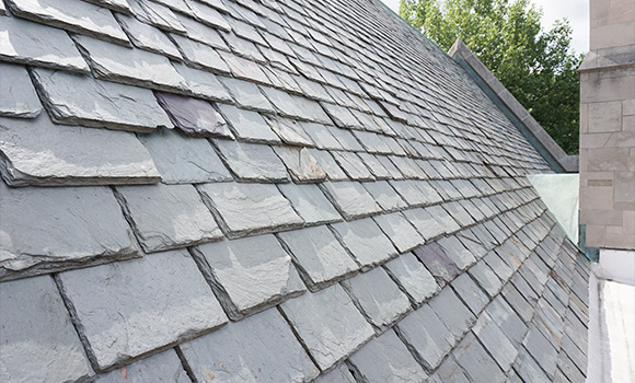slate roof tiles with varying colors and textures showing a sloped design ideal for five-star building aesthetics