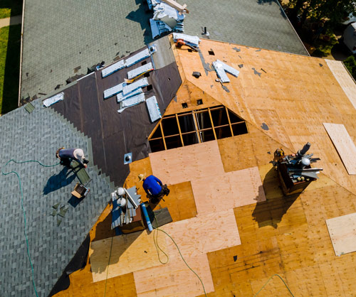 Roofers replacing a pitched roof